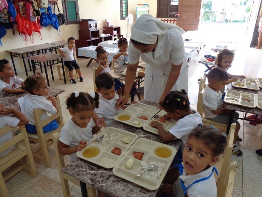 Children in Havana enjoying a meal from the sisters. 
