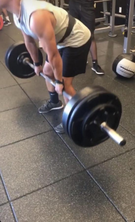 Students lifting weights in weight room