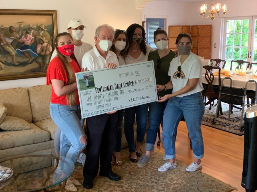 Father Frank, Ms. De La Guardia, and SALTT alumni with the $100,000 check raised for the families of the Guatemalan Maya Center.