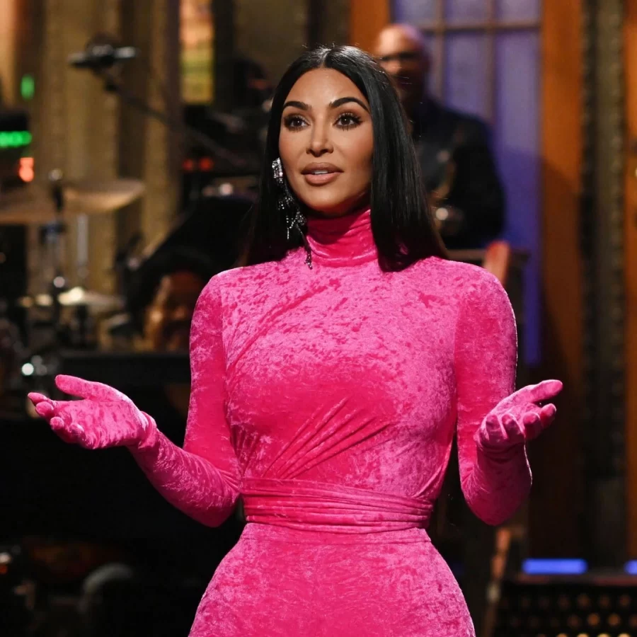 Kim Kardashian wore a hot pink bodysuit and diamond earrings for her introduction to the show. 