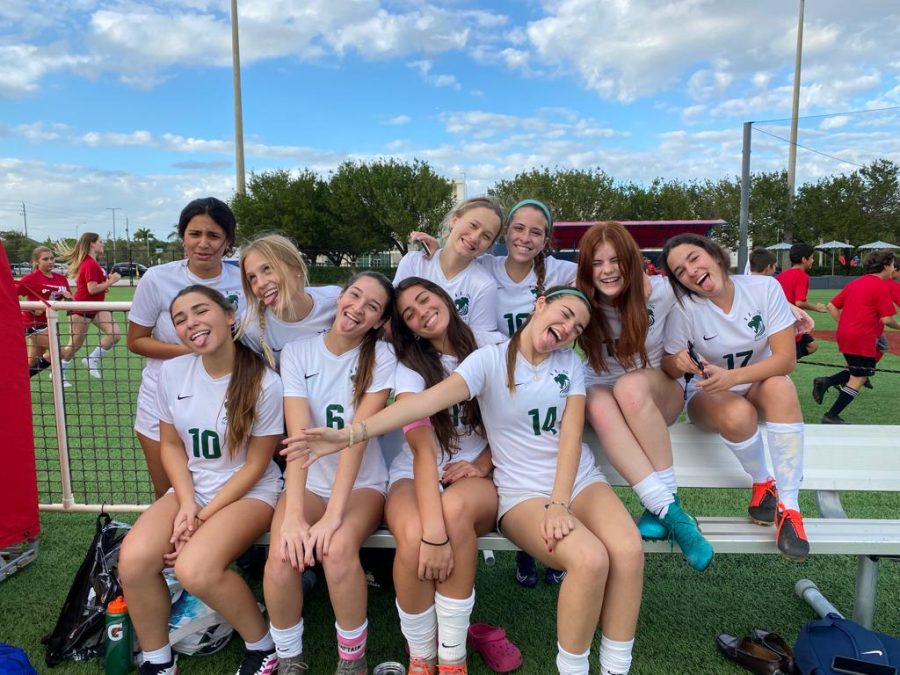 Hanah,( bottom row, second to the left) with her senior teammates at a match.