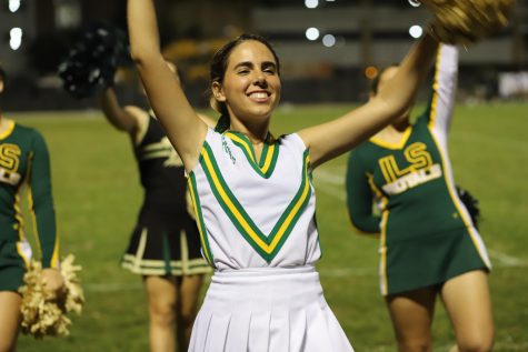 Senior Sofia Plasencia, a Varsity Cheerleader, enthusiastically supports the team.