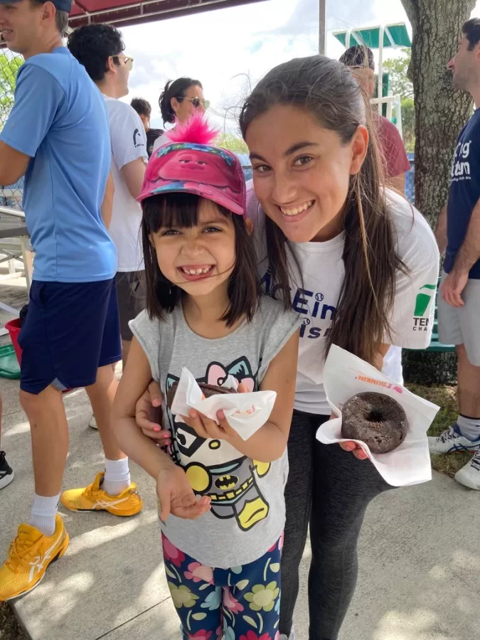 Isabella and one of the young participants at an ACEing Autism event.