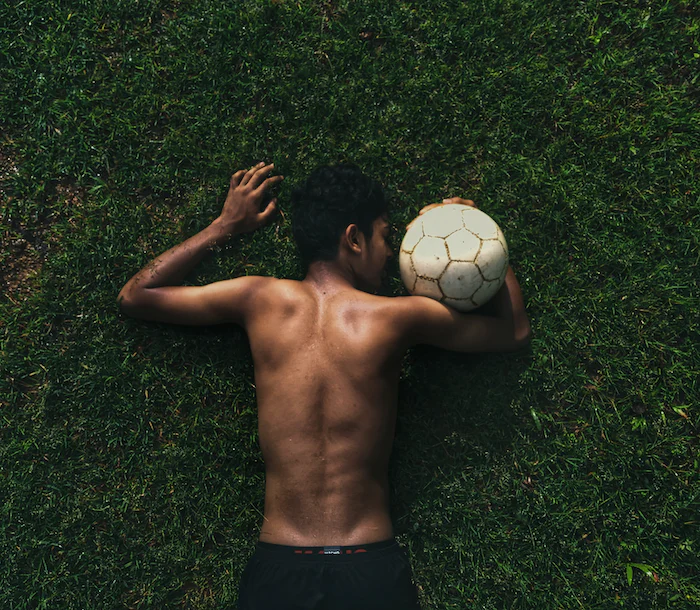 A picture of a kid who is holding a soccer ball