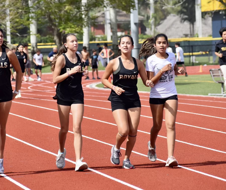 Three sophomores warming up for their track and field meet at Belen Jesuit School. 