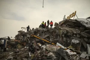 Photos of the destruction in Syria and rescuers helping find people.