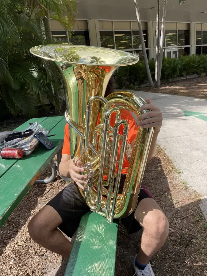 Tuba player and sophomore Etienne at the of the first day of Catholic Schools Week, when ILS celebrated Don Bosco Day. The tuba is so big, it is hard to see him. 