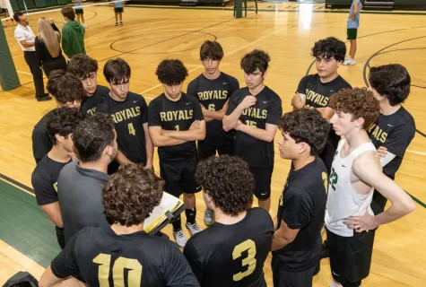 Boys JV Volleyball team huddle during a game with Coach Andres Saladrigas.