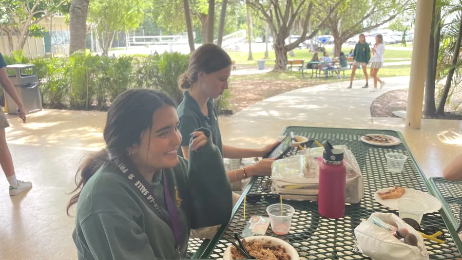 Freshman Andrea Camacho Fontes talks to her friends during lunch about her summer plans. 