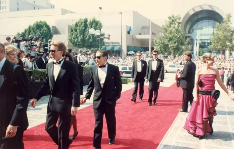 The photo represents film industry people strutting the red carpet to celebrate their performances as well as the writing which made those performances come to life.