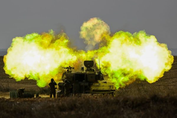 A shell fired by Israel discharges over Gaza in the ongoing war between Israel and Hamas.