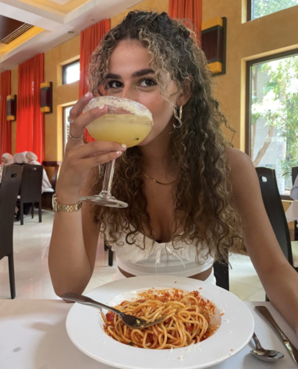 A photo of Jasmine Rassi’s sister eating pasta in an Italian restaurant.  
