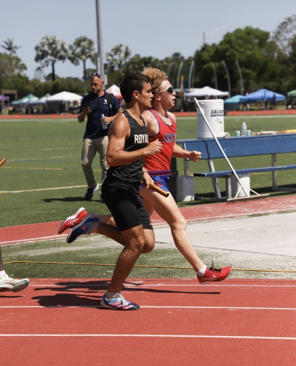 Senior Emmanuel Roca races to the finish line at a Track and Field meet.