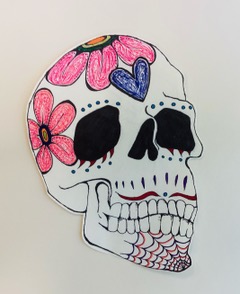 A sugar skull illustrated using ink and marker in honor of Day of the Dead.