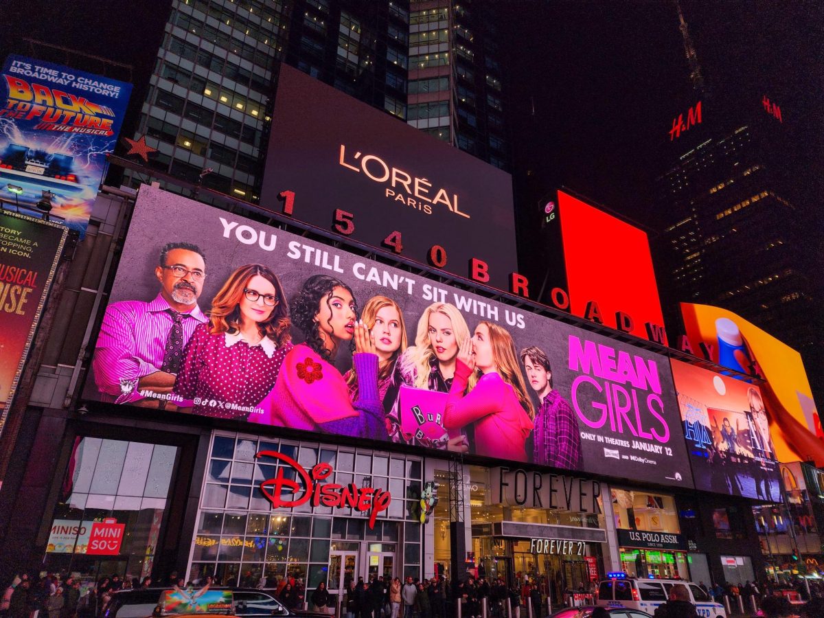 The New Mean Girls Movie poster advertises the film on the busy streets of NYC. 