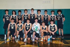 The Boys Varsity Volleyball team gather for a group picture in the school gym.