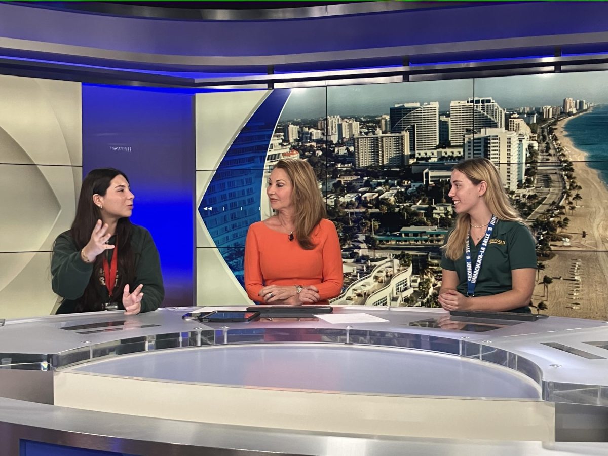 Renata Alvarez Gil and Gianna Ferrera, both from LTV, sit at the anchors desk with CBS 4 anchor Marybel Rodriguez as they experience what it is like to be in that role.