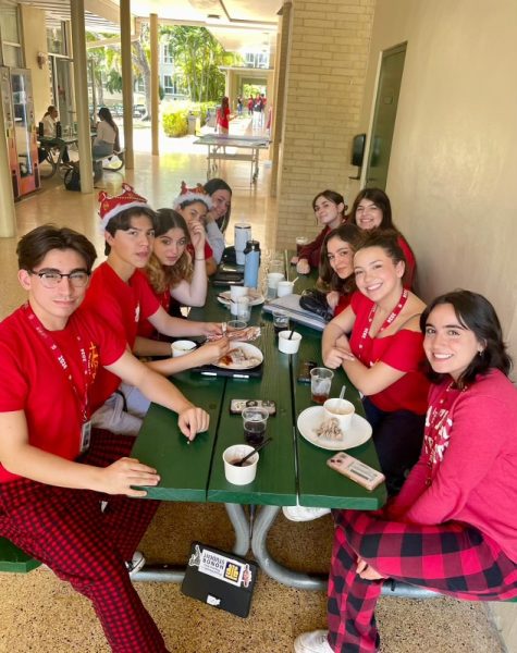 A group of seniors celebrates their last day of classes decked out in their class color, red.