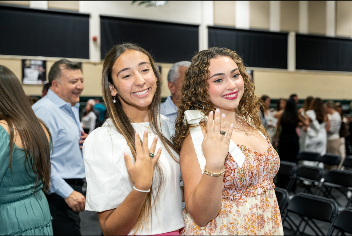 Juniors Sunshine Garcia and Mia Gomez celebrate.