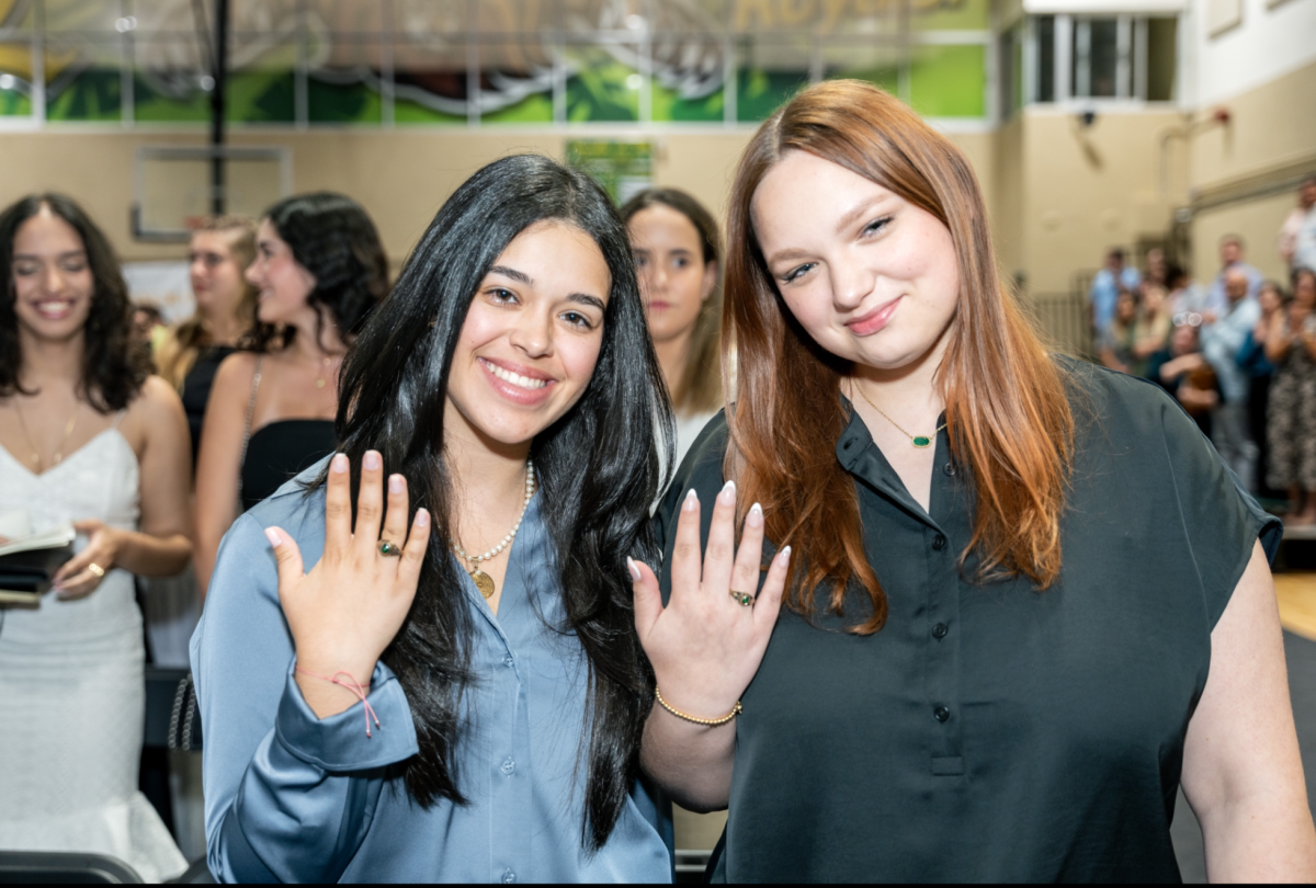 Juniors Katerina Garcia and Abigail Figueroa show off their new junior rings.