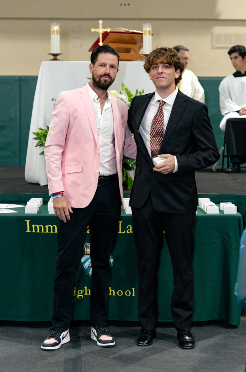 Dean of students, Mr. James Rydborn, gave each student their junior ring and posed for a photo with them. Here he is with Marco Andres.