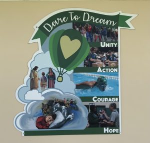 Posters, such as this one adorning the 400 building, promote the strenna or Salesian motto for ILS in 2024-2025, Dare to Dream.