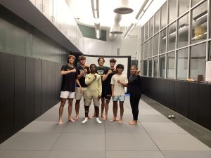 Judo students learning with their instructor, Ms Dirulus Gonzalez, in order to learn proper form 