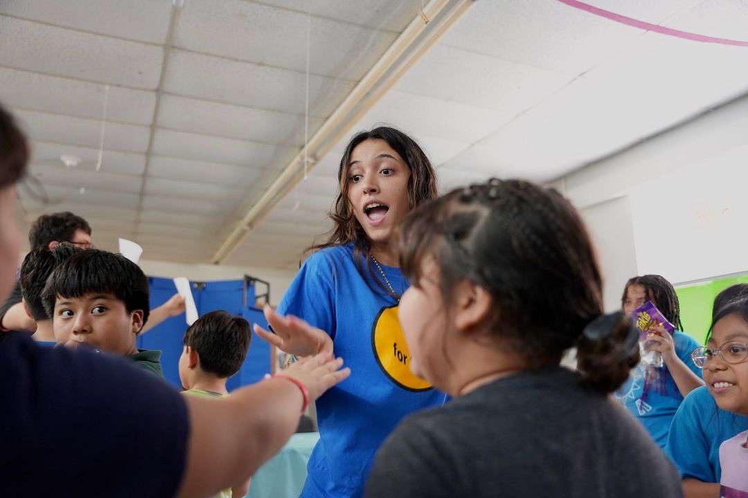 Senior Cristina Cabrera dancing with Maya S.A.L.T.T. kids