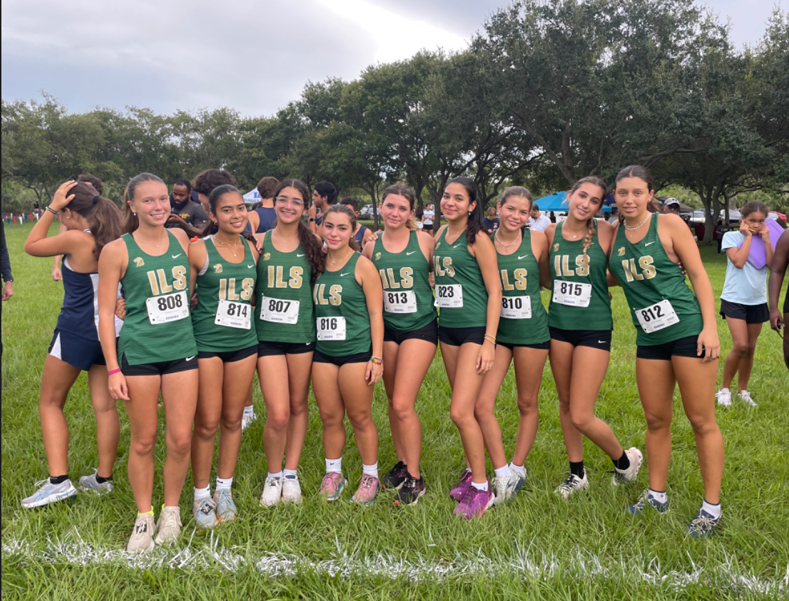 The ILS Girls Cross Country team gather to prepare and stretch for a meet.