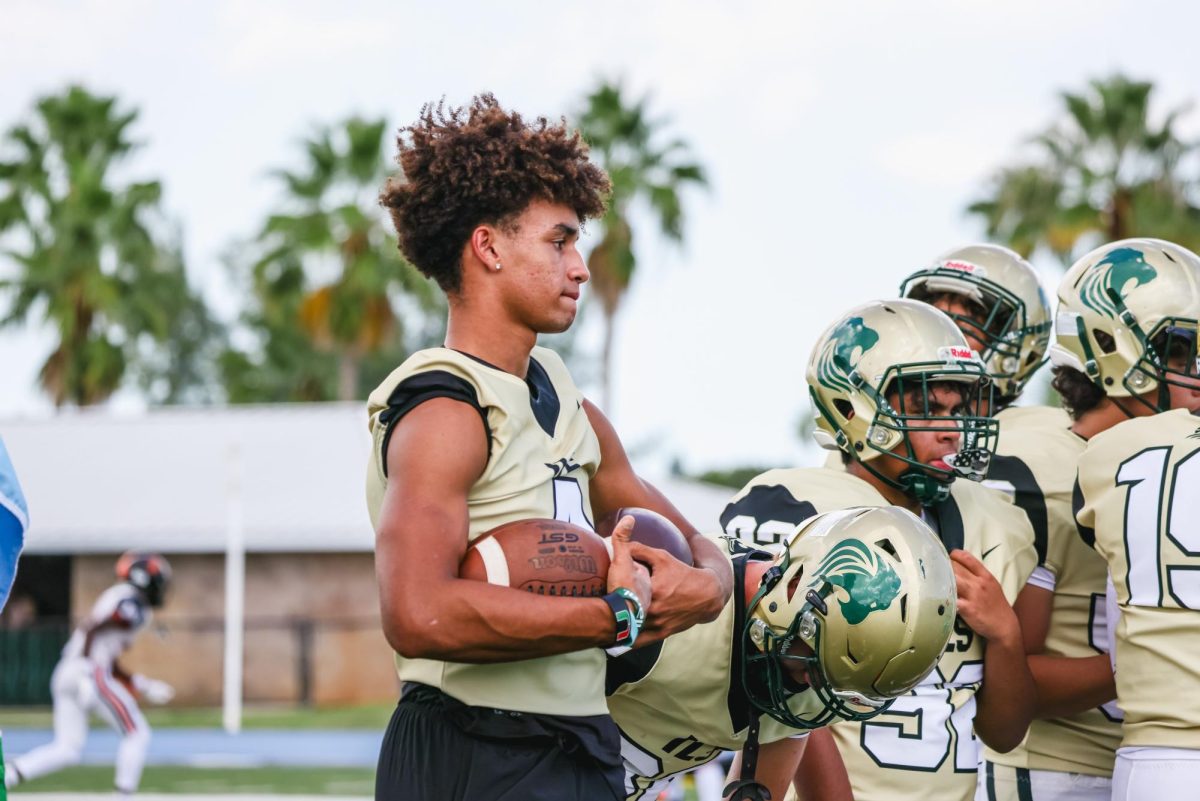 Football players warming up for an important game as they listen to a team pep talk.