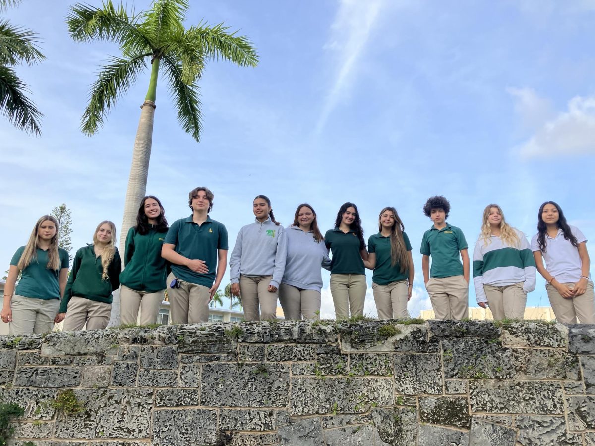 The 2024-2025 editors and writers for the Royal Courier gather together on the bridge leading to the 800 building.