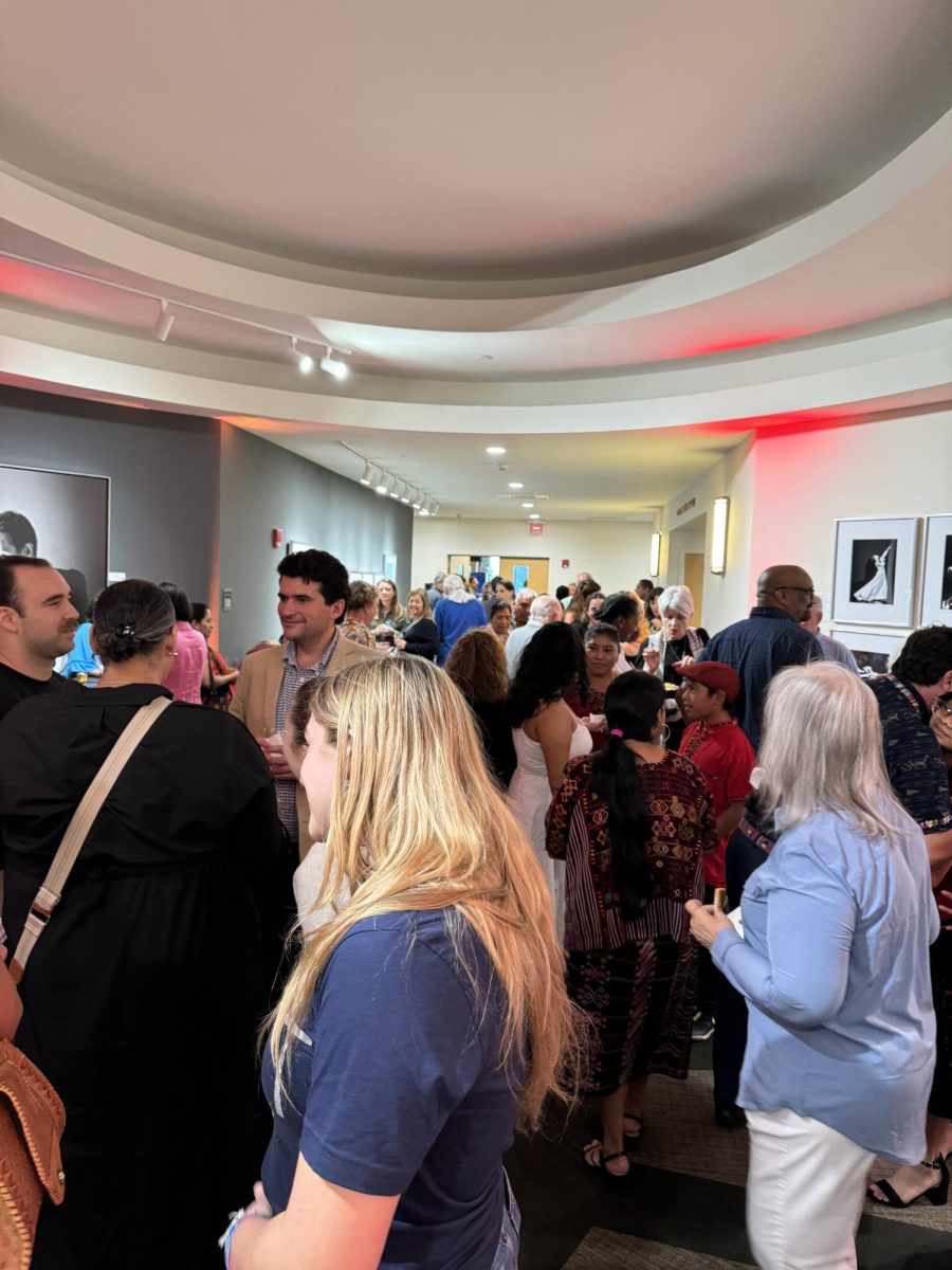 At the Reception area, audience members gathered before the film, talking, and enjoying appetizers. 