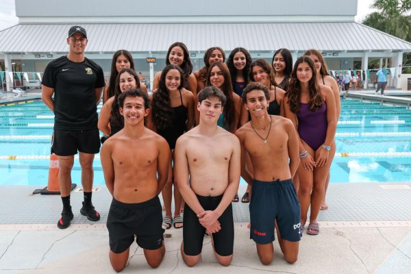 ILS boys and girls Swim team pose for a group photo after competing at a meet.