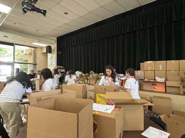 Wishbone volunteers help to pack the hundred of boxes, readying them to be donated to families in need.