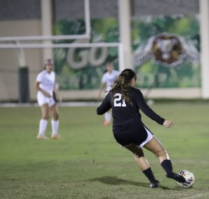 ILS girls soccer player Luna Fernandez takes a free kick against Lourdes.