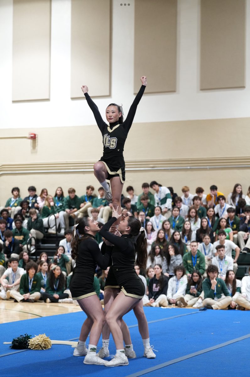 Cheerleaders showcase their routine before the ILS community at the school pep rally.