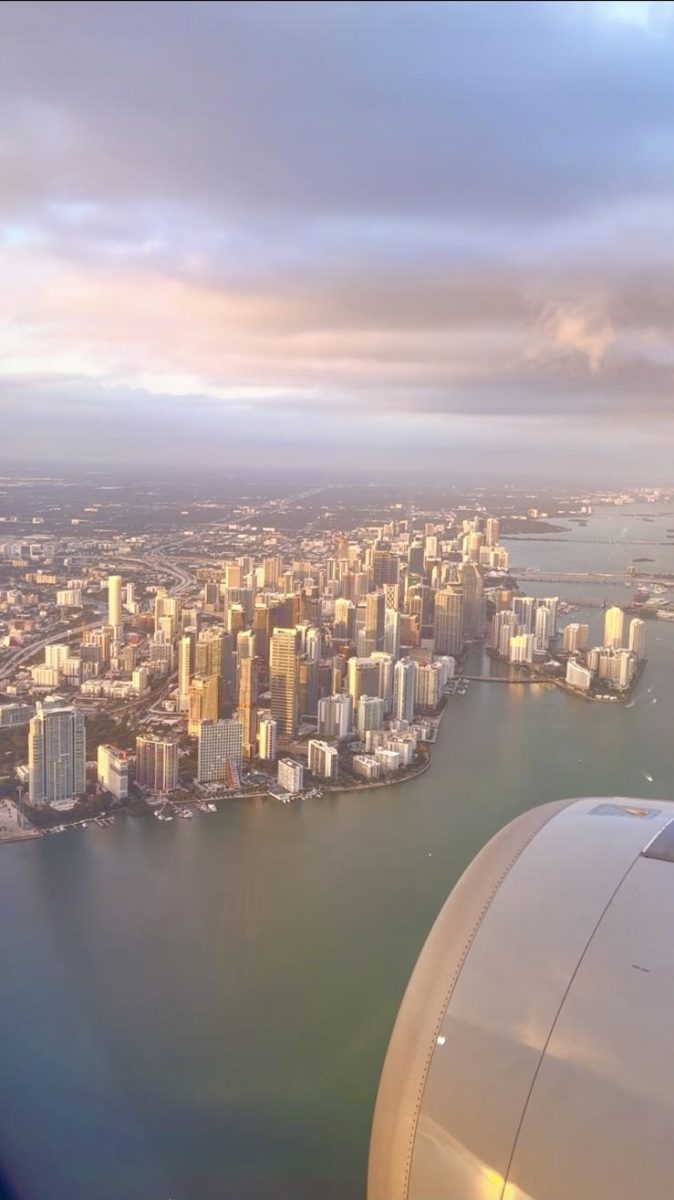 Miami being viewed from above with the plane engine in view.