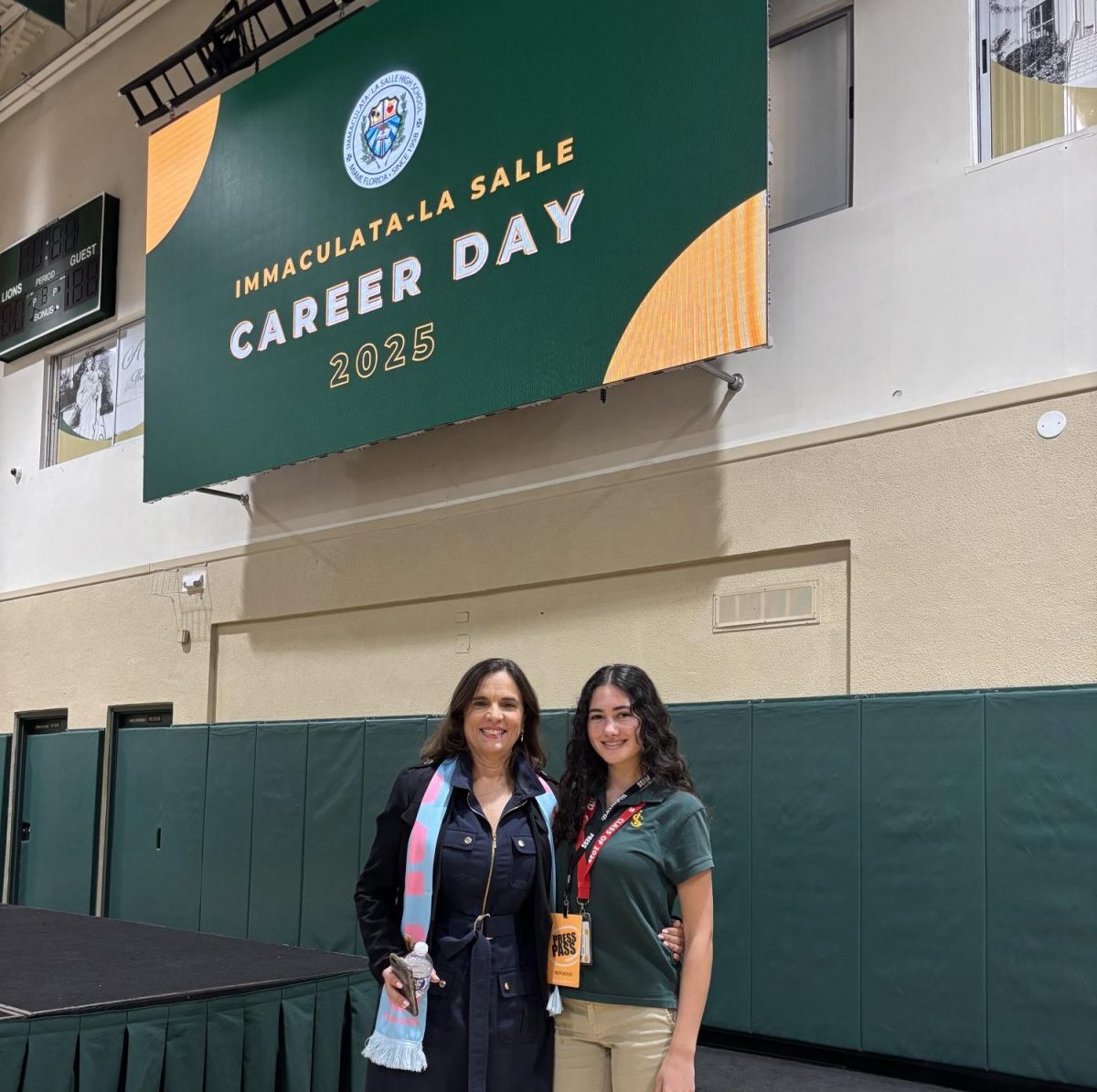 Senior Alexandra Perez and Media Director Cristina Ramirez pose to display FIFA scarves handed out by keynote speaker Mr. Rodney Barreto.