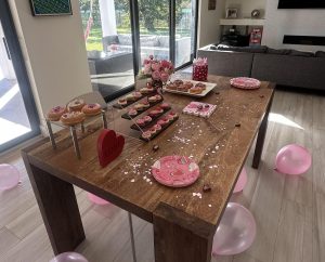 A festive Galentine's Day spread can feature cookies, donuts, and other amazing sweet treats.