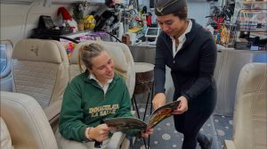 Emma Blume sits and discusses with a Sky Coffee employee. 