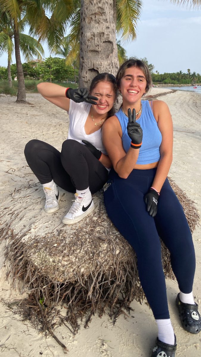 After a long day of environmental work, two KMLOEC volunteers take a break under the shade of a palm tree. Their efforts in beach cleanups and habitat restoration contribute to preserving South Florida’s natural beauty and marine life.