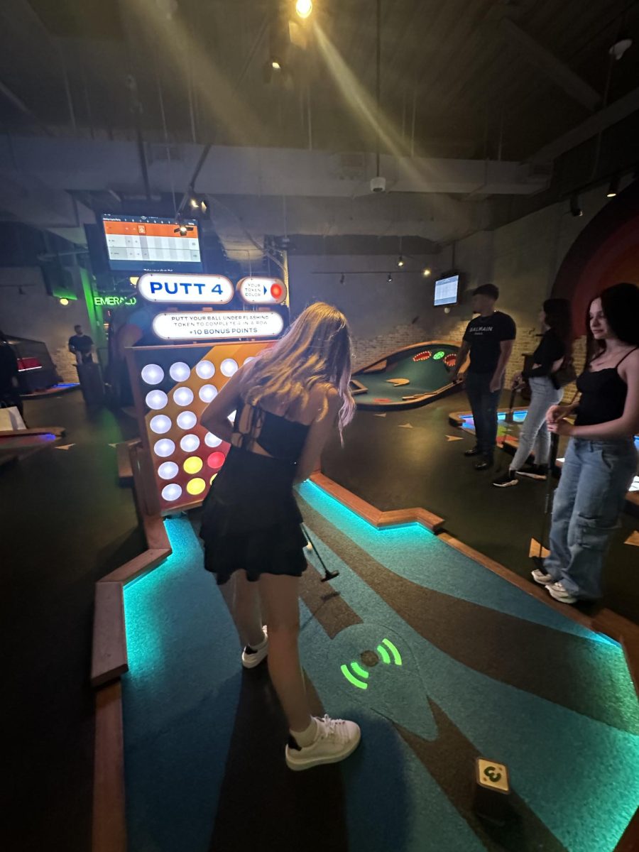 A group of friends play mini golf at Brickell City Centre Puttshack. 