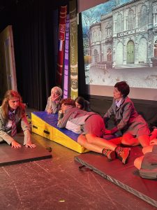 This behind the scenes picture captures the Drama Club’s Matilda production from a year ago.