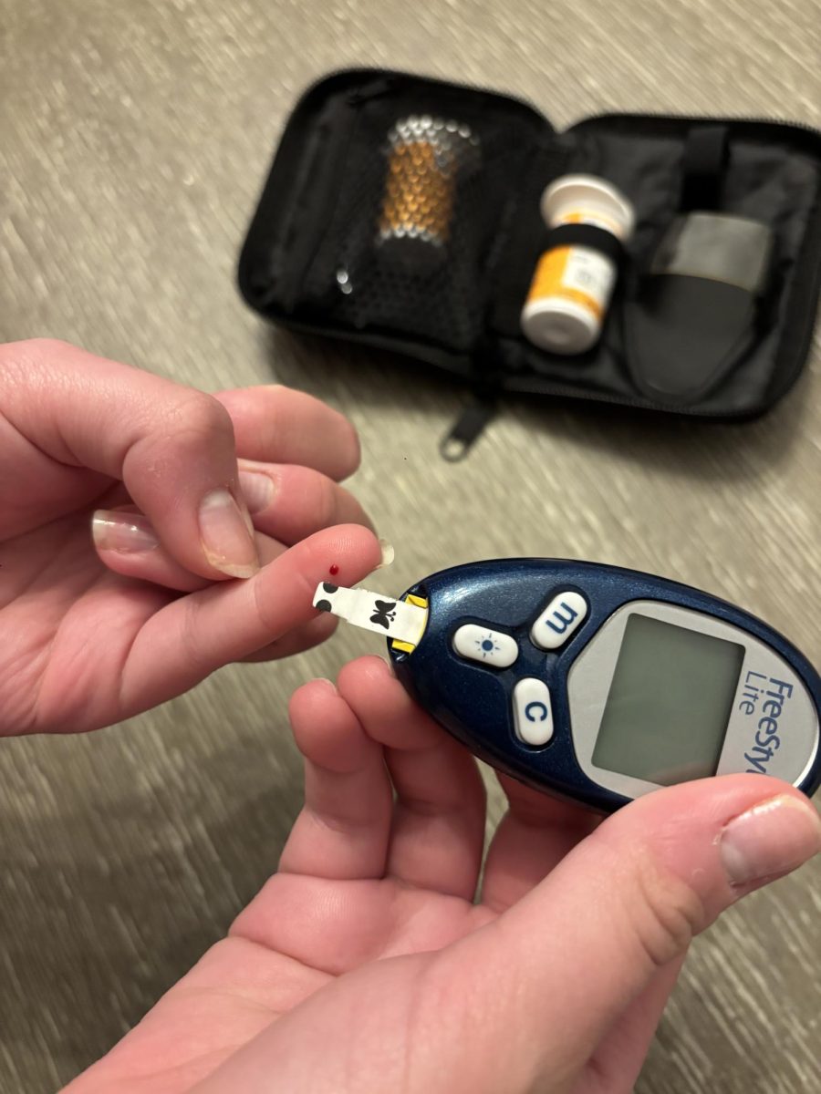 Leila Perez, sister of senior Alexandra Perez, has lived with Type 1 Diabetes since she was 6-years-old. Now 14, she displays a typical aspect of her day: checking her blood sugar.