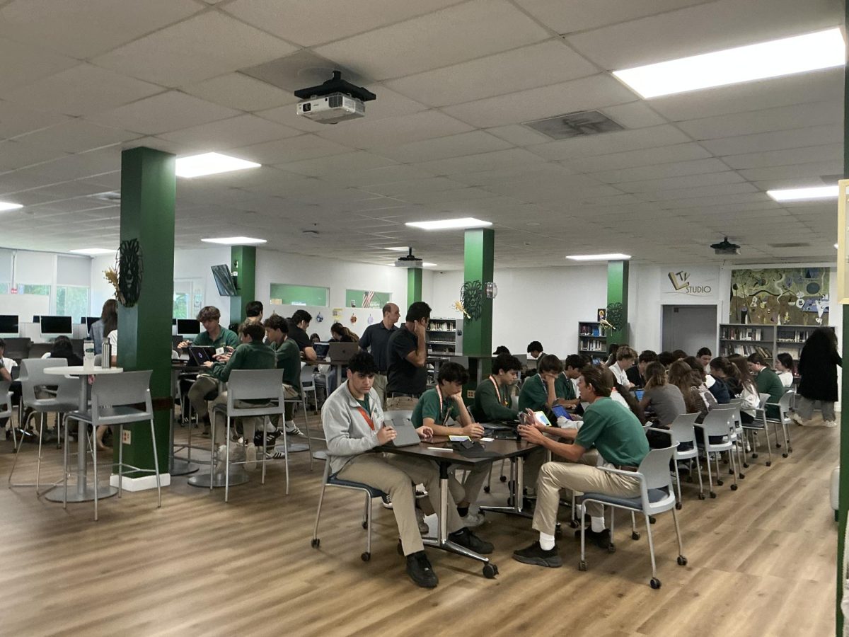 A sophomore English class figures out how to transfer things over to the new iPad.