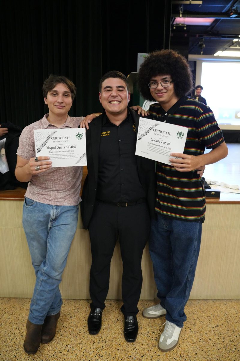 Band Director Armando Alicondu, Seniors Miguel Suarez-Cabal and Etienne Ferrel posing together
