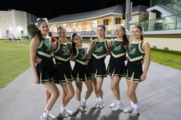 ILS Girls Cheer team bonds after enthusiastically supporting the Varsity Football team.