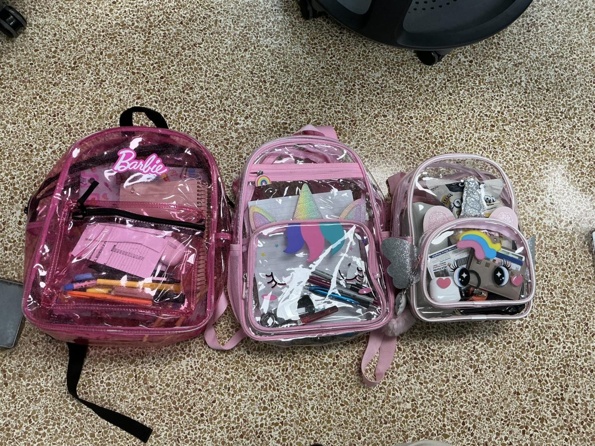 Senior students participate in the annual kid backpack tradition, carrying smaller, playful bags to mark their last year.