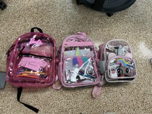 Senior students participate in the annual kid backpack tradition, carrying smaller, playful bags to mark their last year.
