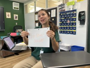 Junior Marina La Mendola shows support for Schlep by holding up a sign featuring a popular meme.